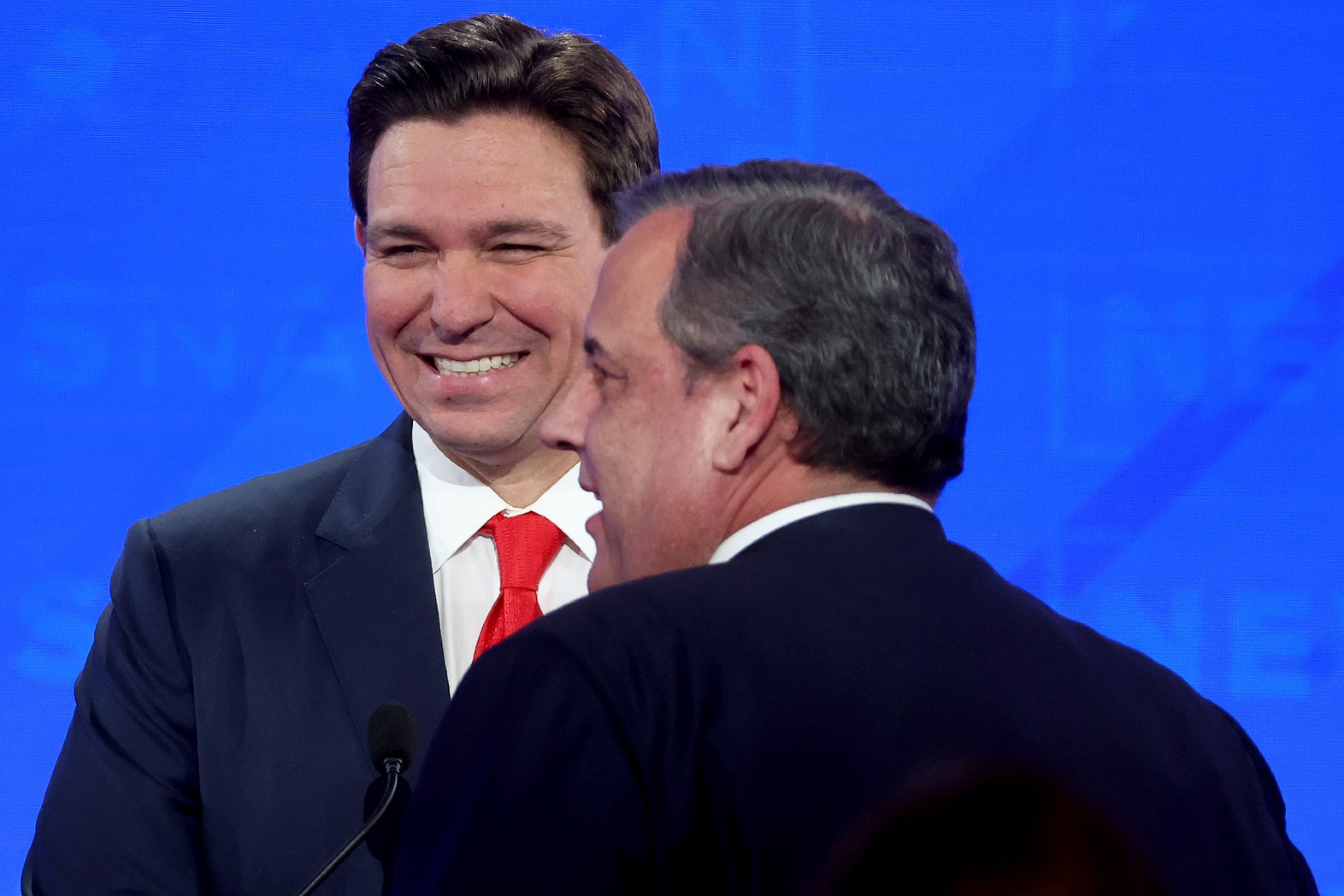 Republican presidential candidates Florida Gov. Ron DeSantis (L) and former New Jersey Gov. Chris Christie talk during a commercial break in the NewsNation Republican Presidential Primary Debate at the University of Alabama Moody Music Hall on December 6, 2023 in Tuscaloosa, Alabama. (Justin Sullivan/Getty Images)