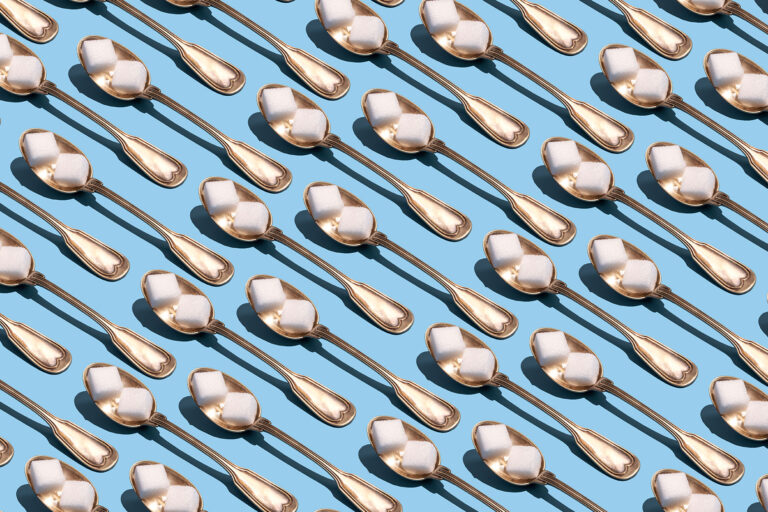 Sugar cubes in metallic spoons (Getty Images/Yulia Reznikov)