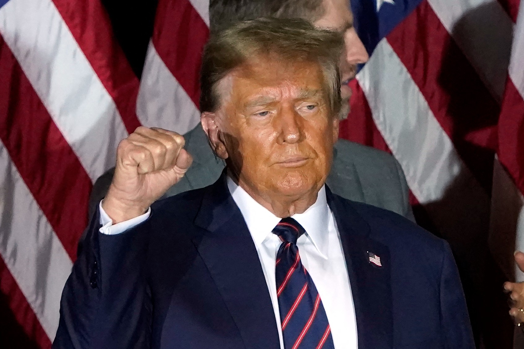 Republican presidential hopeful and former US President Donald Trump holds up his fist during an Election Night Party in Nashua, New Hampshire, on January 23, 2024. (TIMOTHY A. CLARY/AFP via Getty Images)