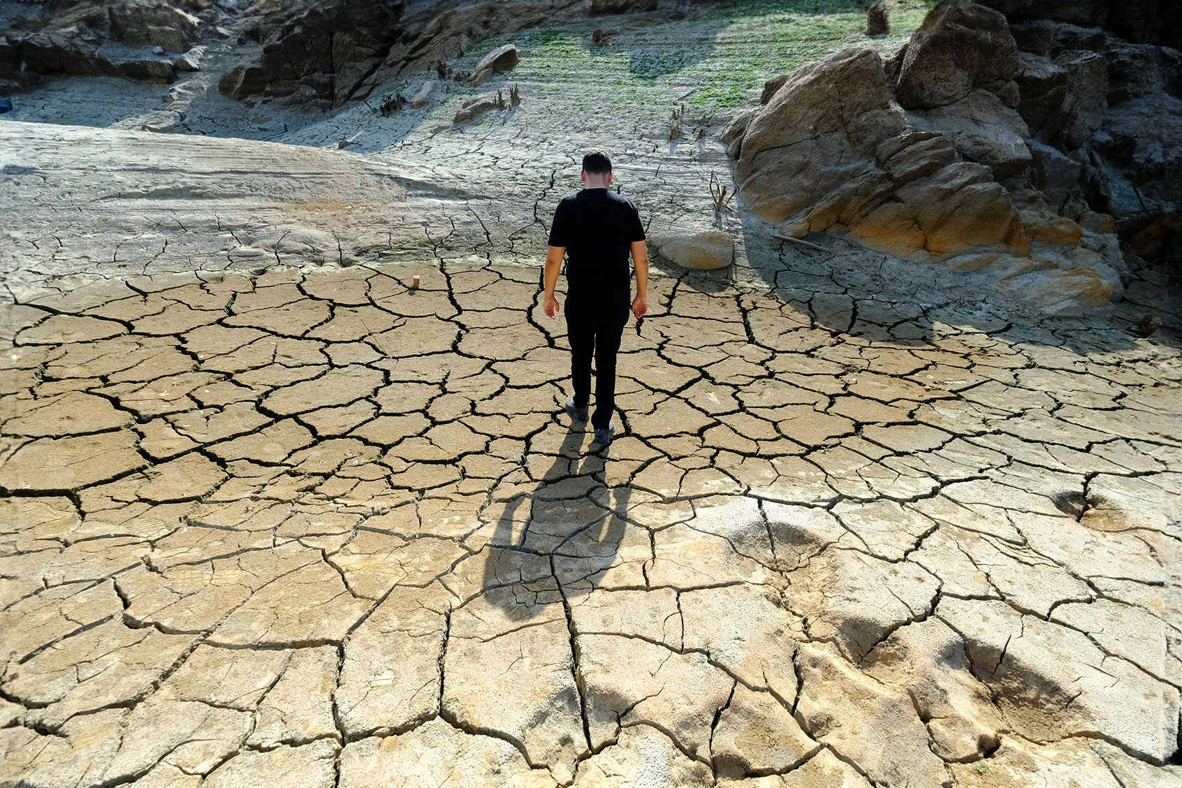A man is seen walking in the area where the dam water recedes near Caglayan Bridge in Kirklareli, Turkiye on October 04, 2023. (Ozgun Tiran/Anadolu via Getty Images)