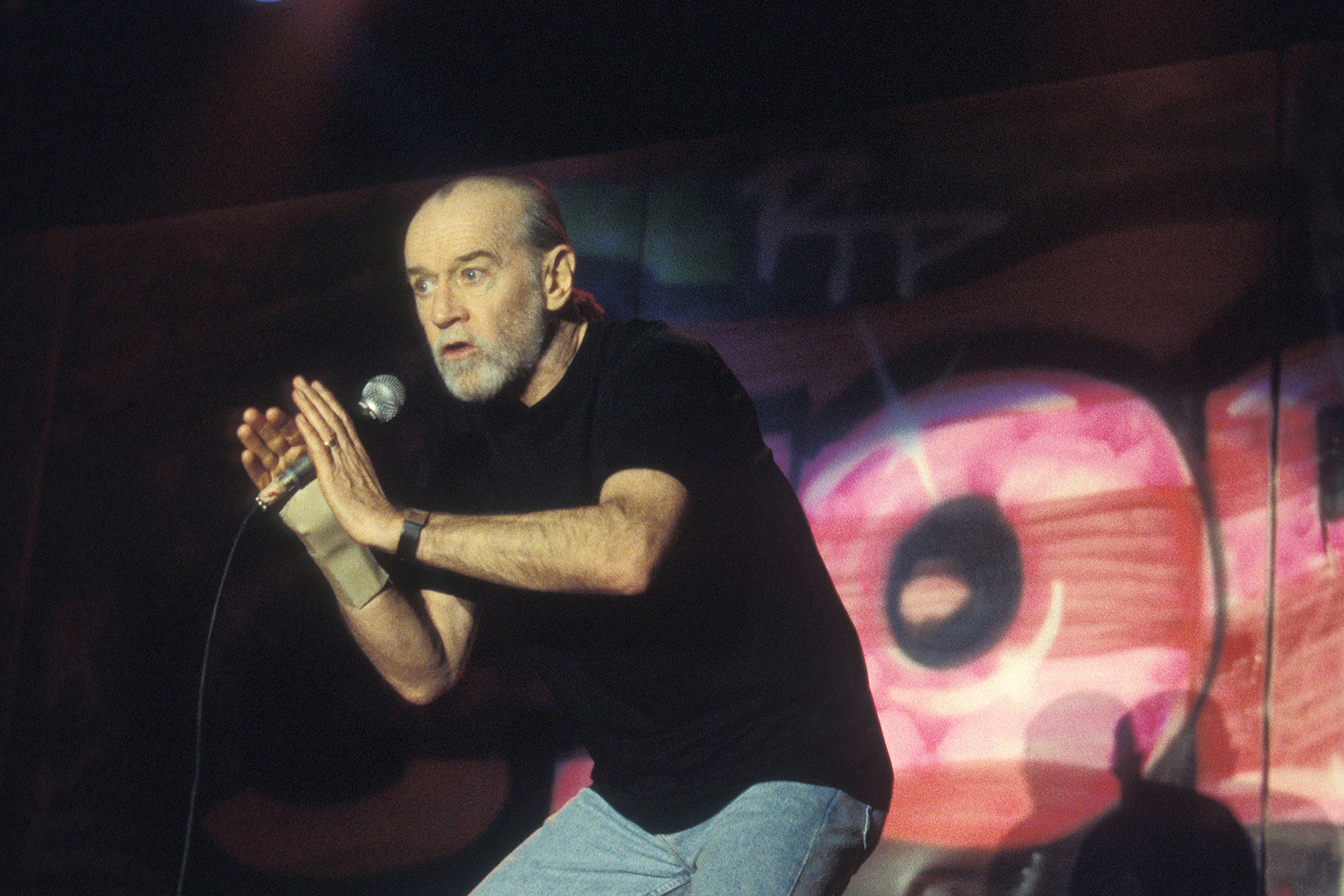 Stand up comedian, actor and author George Carlin is shown performing on stage during a live concert appearance on January 13, 1996. (John Atashian/Getty Images)