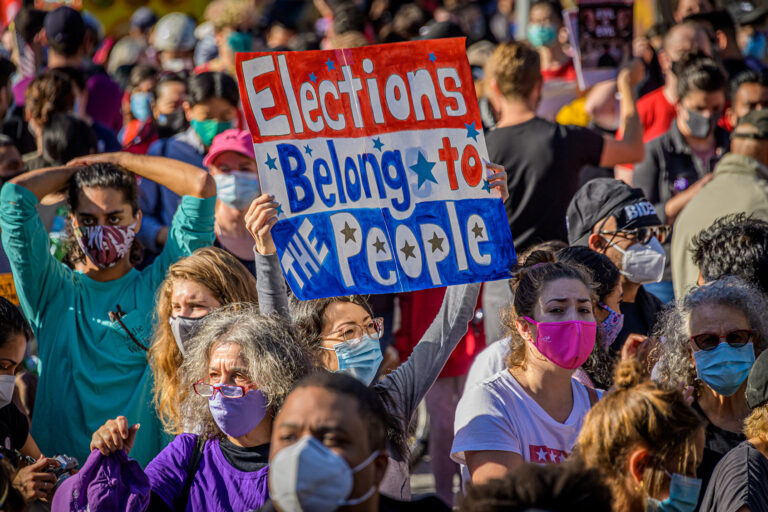 A participant holding a sign at the celebratory march. Thousands of New Yorkers joined members of the Protect the Results: New York City Coalition, a group formed by over 90 local community organizations at Columbus Circle for the March to Protect The Results. (Erik McGregor/LightRocket via Getty Images)
