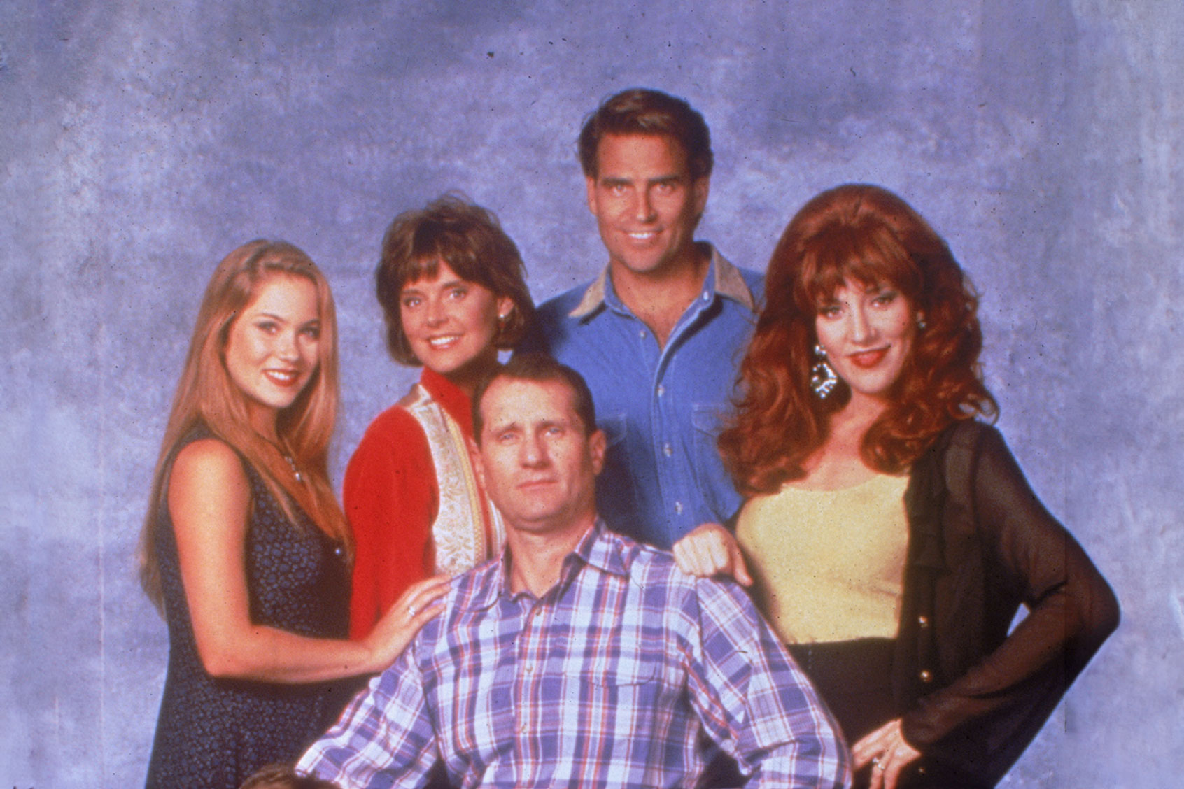 Promotional studio portrait of the cast of the television series, 'Married...With Children,' circa 1994. Christina Applegate, Amanda Bearse, Ed O'Neill, Ted McGinley, Katey Sagal and David Faustino (not shown). (Columbia Tristar/Fotos International/Getty Images)