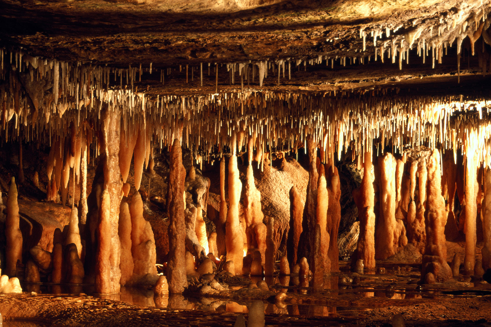 Stalactites and stalagmites are calcium carbonate deposit formations. (Getty Images/Hans Strand)