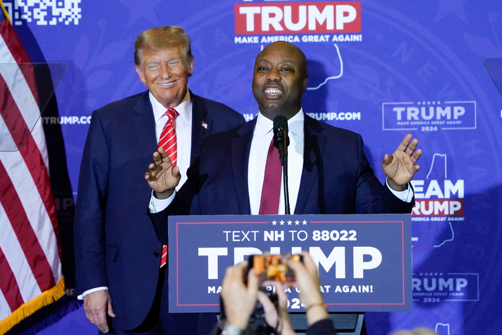 US Republican Senator from South Carolina Tim Scott speaks as Republican presidential hopeful and former US President Donald Trump listens during a campaign event in Concord, New Hampshire, on January 19, 2024. (TIMOTHY A. CLARY/AFP via Getty Images)
