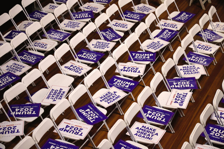 Campaign signs for Republican presidential candidate and former President Donald Trump await supporters in their seats at the Rochester Opera House ahead of a campaign rally on January 21, 2024 in Rochester, New Hampshire. (Chip Somodevilla/Getty Images)
