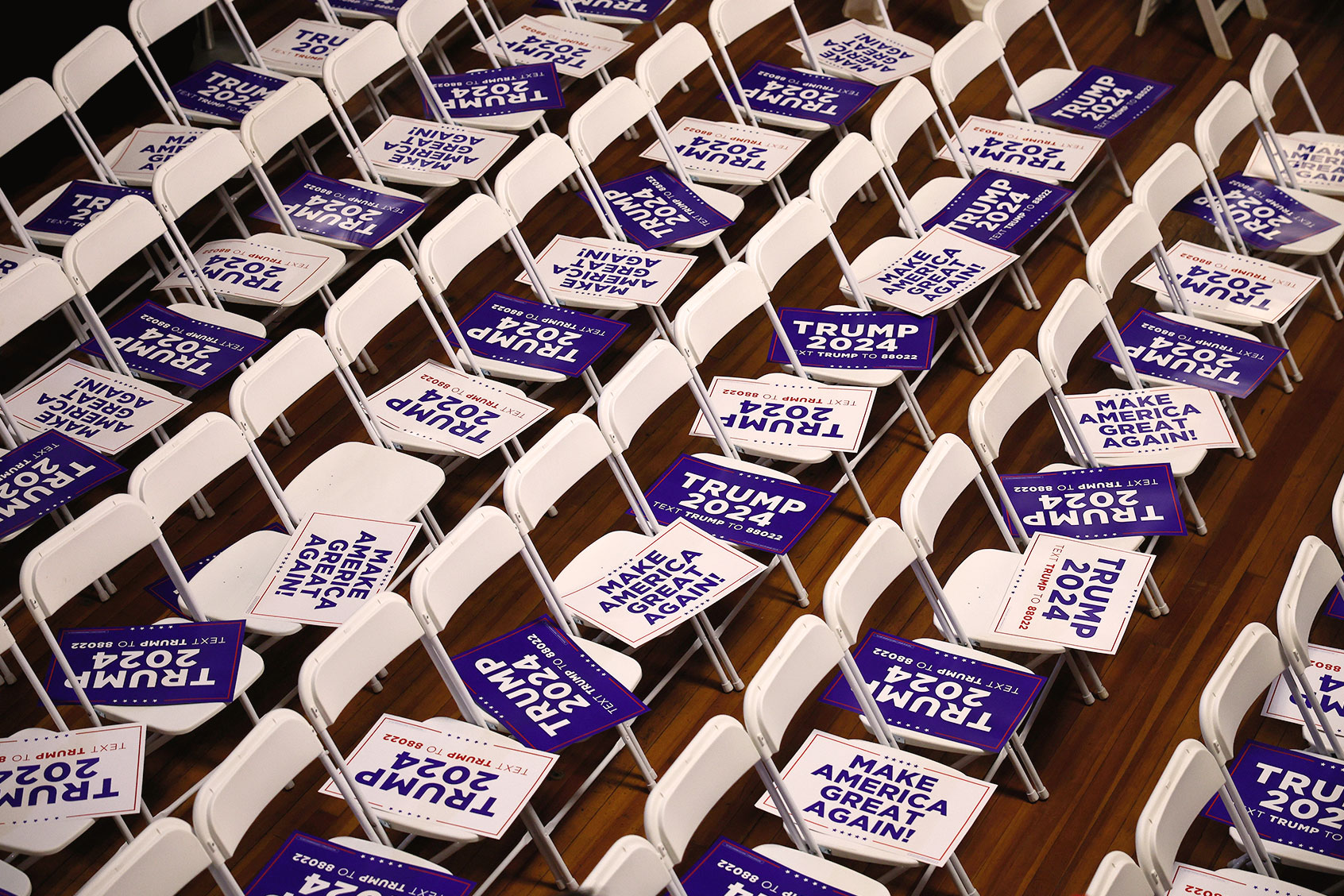 Campaign signs for Republican presidential candidate and former President Donald Trump await supporters in their seats at the Rochester Opera House ahead of a campaign rally on January 21, 2024 in Rochester, New Hampshire. (Chip Somodevilla/Getty Images)