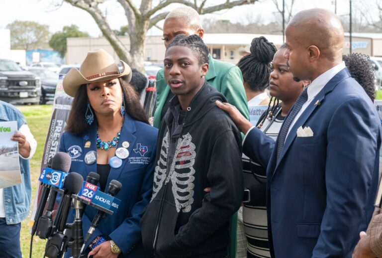 State Rep. Ron Reynolds (right) with Darryl George (center) makes comments before a hearing regarding George's punishment for violating school dress code policy because of his hair style, Feb. 22, 2024 at the Chambers County Courthouse. (Kirk Sides/Houston Chronicle via Getty Images)
