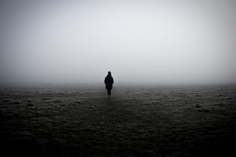 A closeup of a woman walking in a foggy field (Wirestock / Getty Images)