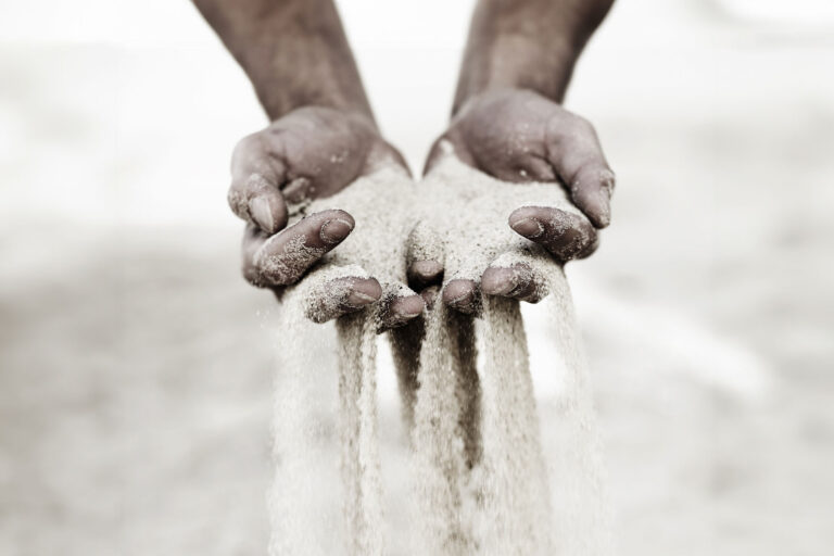 Sand slipping through fingers (Getty Images/PeopleImages)