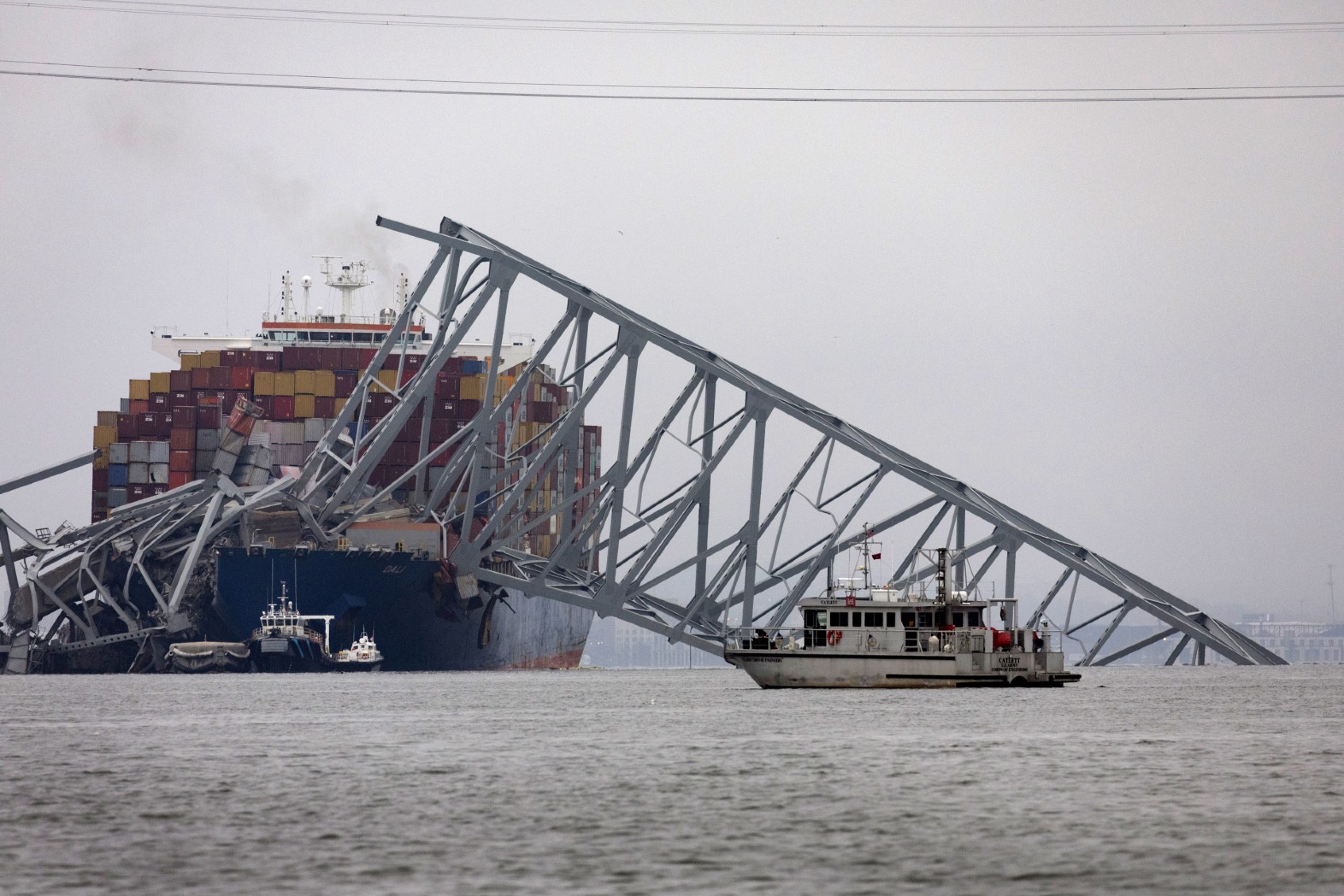 Workers continue to investigate and search for victims at the scene after the cargo ship Dali collided with the Francis Scott Key Bridge yesterday causing it to collapse, on March 27, 2024 in Baltimore, Maryland. (Scott Olson/Getty Images)