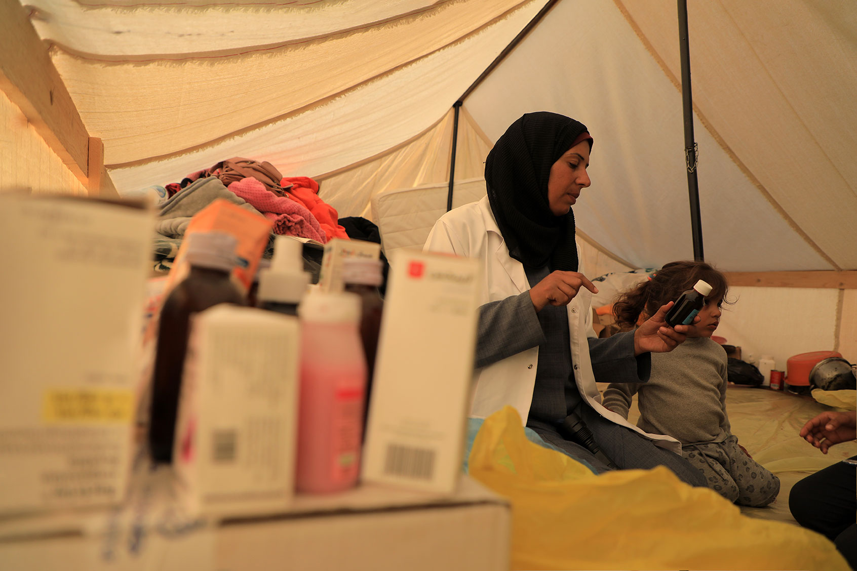 A doctor picks medicines for a patient at a temporary clinic in the southern Gaza Strip city of Rafah, on Jan. 8, 2024. (Rizek Abdeljawad/Xinhua via Getty Images)