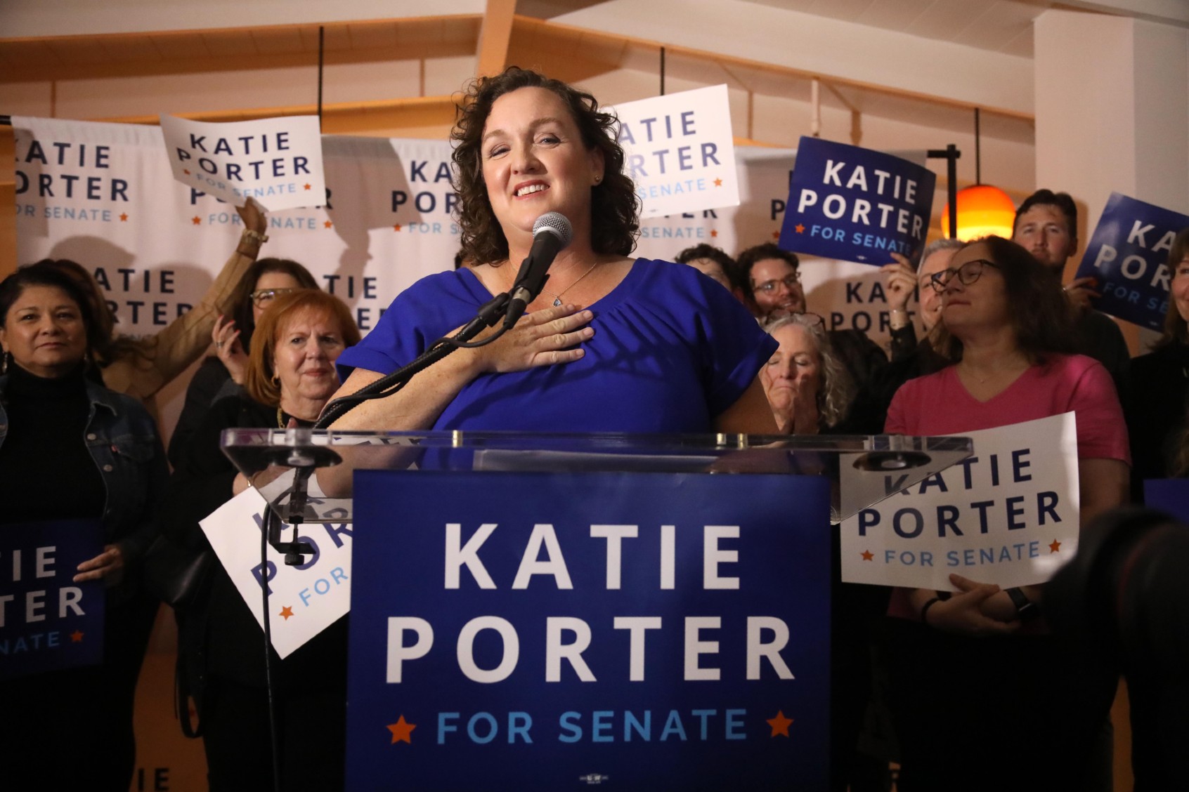 U.S. Representative Katie Porter applauds her daughter Betsy Hoffman, 12, off camera, while she introduces her mother to supporters at Porter's watch party at The Bungalow in Long Beach on March 5, 2024. (Genaro Molina/Los Angeles Times via Getty Images)