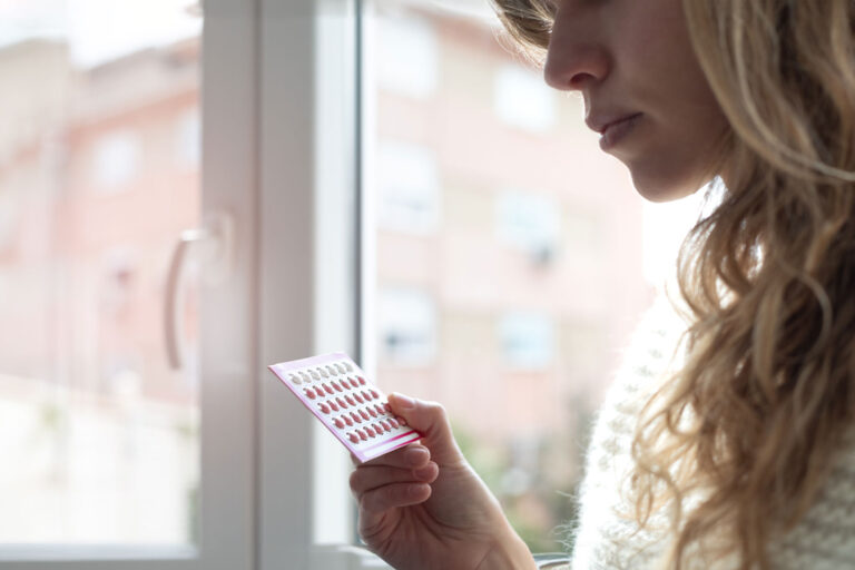 Young woman holding contraceptive pills (Getty Images/Cris Cantón)