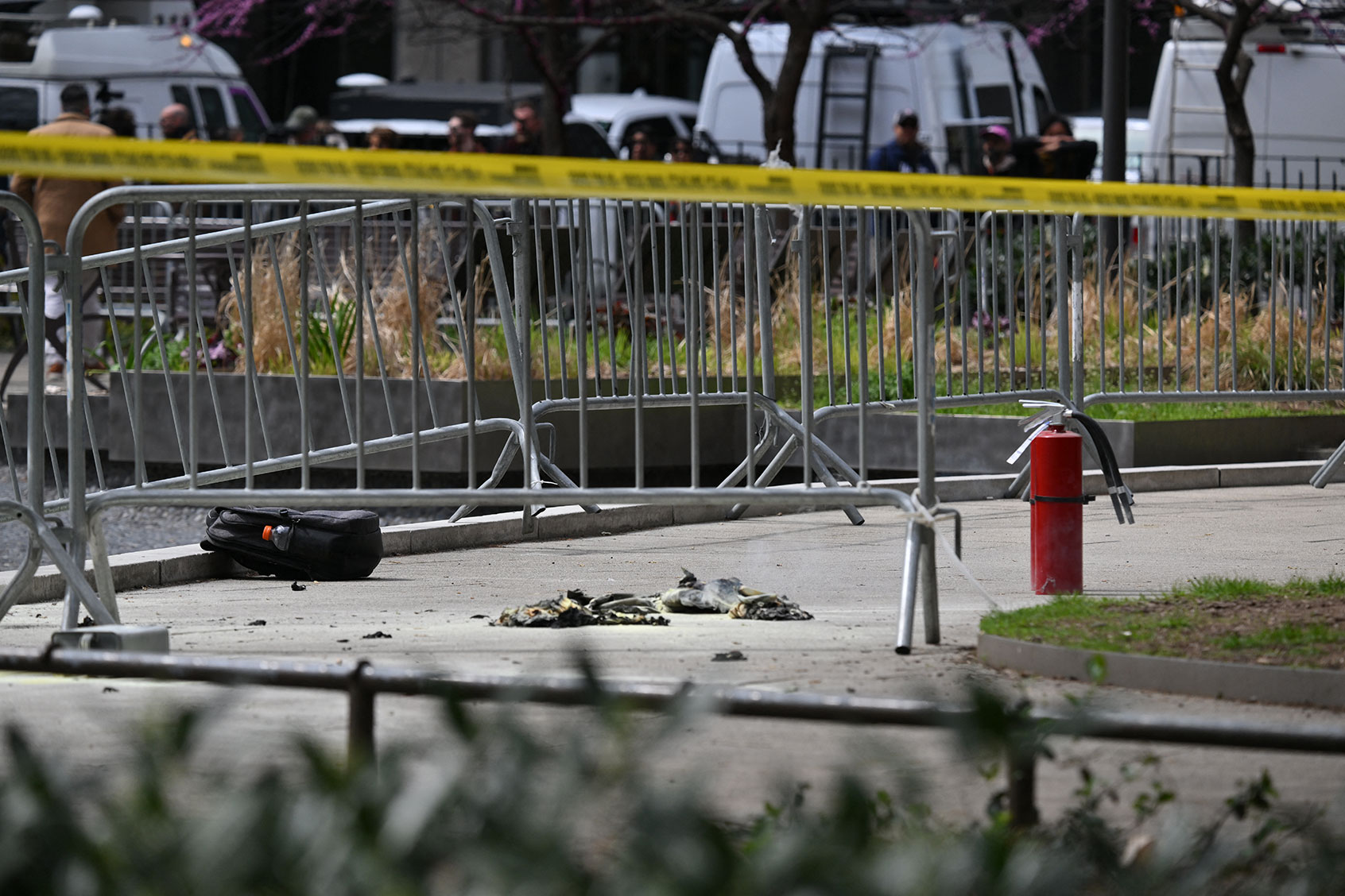 Fire extinguishers (R) are left at the park across from Manhattan Criminal Court in New York City after a man reportedly set himself on fire during the trial of US President Donald Trump, in New York City on April 19, 2024. (ANGELA WEISS/AFP via Getty Images)