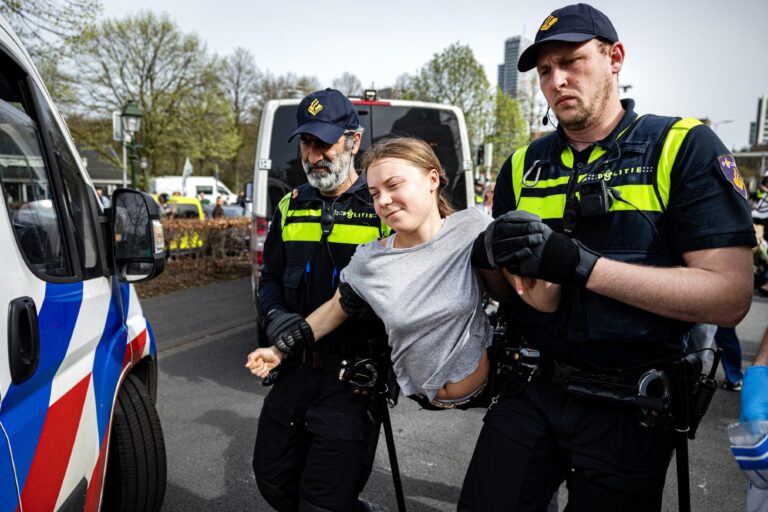 Police detain Swedish climate activist Greta Thunberg (C) during a climate march against fossil subsidies near the highway A12 in the Hague, on April 6, 2024. (RAMON VAN FLYMEN/ANP/AFP via Getty Images)