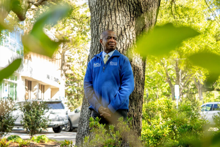 The Medical University of South Carolina is conducting a genetics research project to study how DNA affects health conditions, such as heart disease and cancer. Lee Moultrie, a member of the community advisory board for the project, regularly wears a bright-blue pullover with the words "In Our DNA SC" embroidered on the front to encourage people to enroll in the study. (Gavin McIntyre/KFF News)
