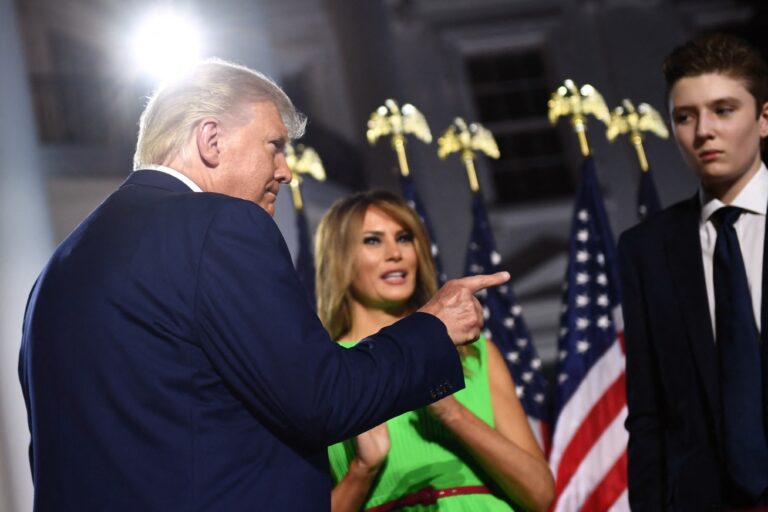Former U.S. President Donald Trump (L) gestures, flanked by former First Lady Melania Trump and son Barron Trump, as they prepare to leave after he delivered his acceptance speech for the Republican Party nomination for reelection during the final day of the Republican National Convention at the South Lawn of the White House in Washington, DC on August 27, 2020. (BRENDAN SMIALOWSKI/AFP via Getty Images)