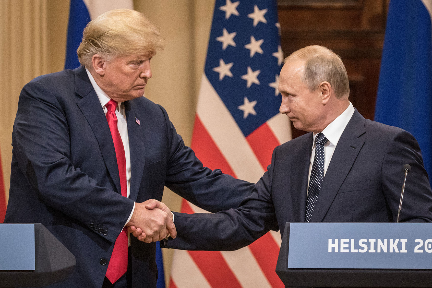 U.S. President Donald Trump (L) and Russian President Vladimir Putin shake hands during a joint press conference after their summit on July 16, 2018 in Helsinki, Finland. (Chris McGrath/Getty Images)