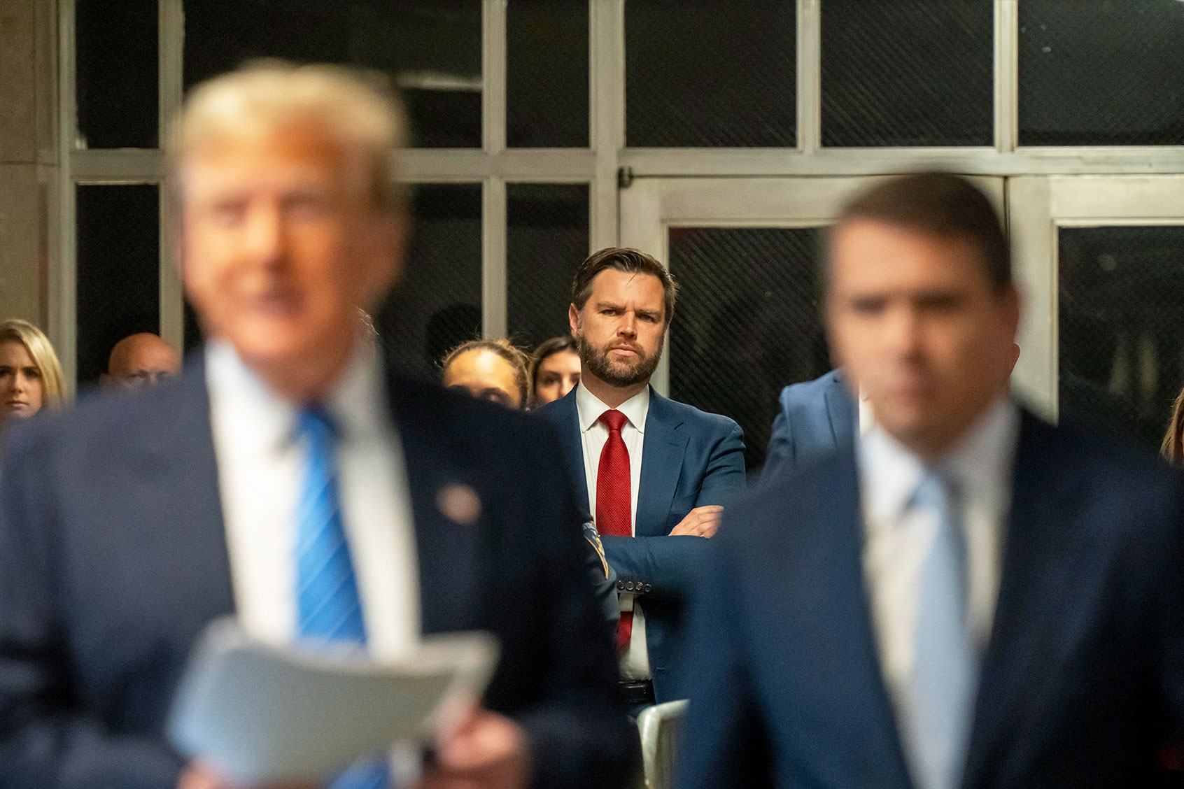 US Senator J.D. Vance (R-OH) listens as former President Donald Trump speaks to reporters before departing Manhattan criminal court on May 13, 2024, in New York where he is on trial for allegedly covering up hush money payments linked to extramarital affairs. (MARK PETERSON/POOL/AFP via Getty Images)