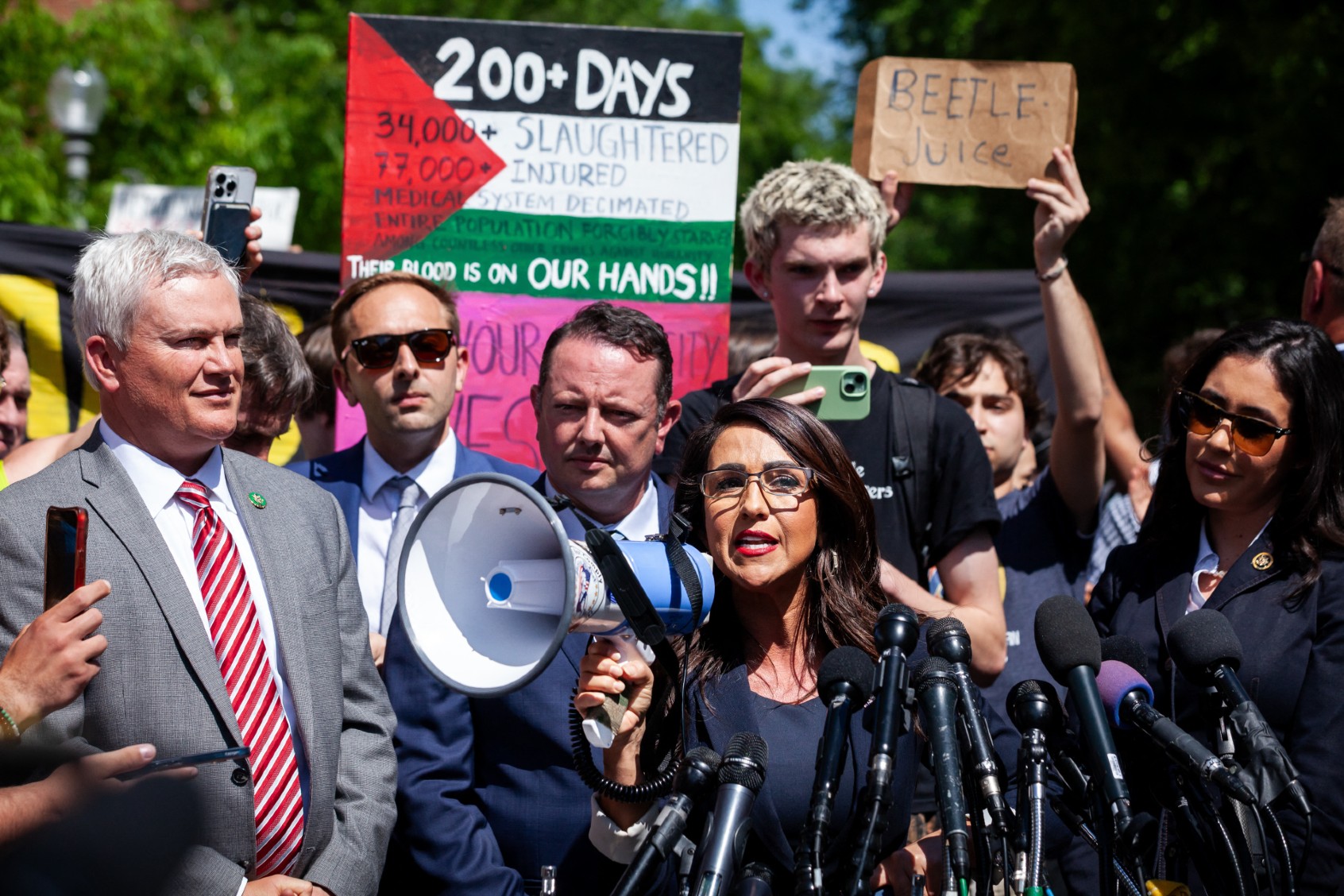 Rep. Lauren Boebert (R-CO) uses a bullhorn to be heard over the crowd noise during a press conference at the George Washington University Gaza encampment, Washington, DC, May 1, 2024. (ALLISON BAILEY/Middle East Images/AFP via Getty Images)
