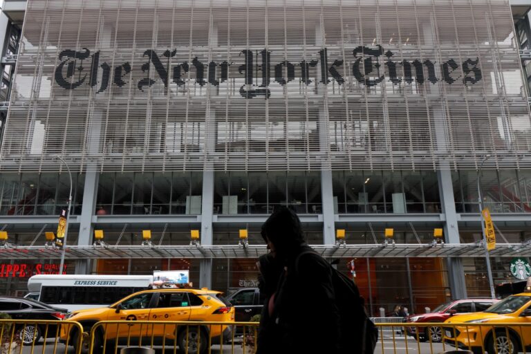 Traffic and pedestrians pass by the New York Times building on 8th Avenue on December 30, 2023, in New York City. (Gary Hershorn/Getty Images)
