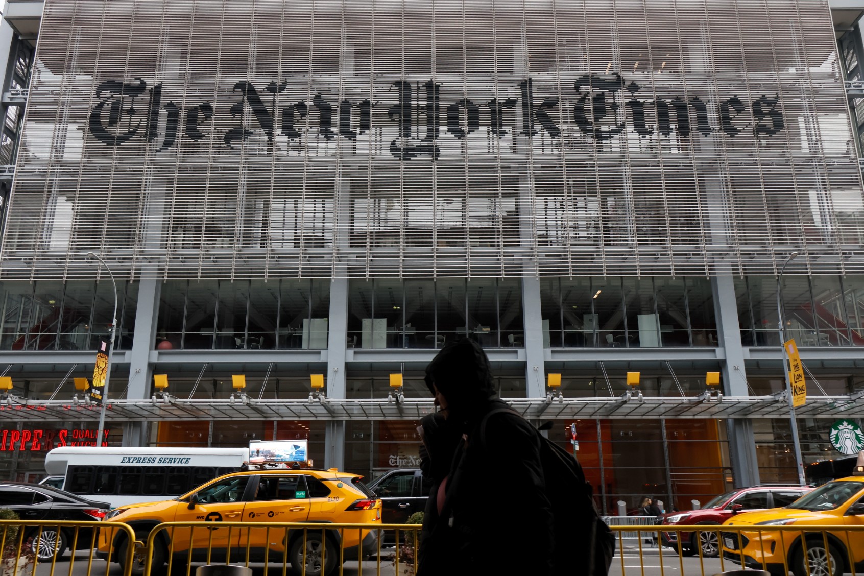Traffic and pedestrians pass by the New York Times building on 8th Avenue on December 30, 2023, in New York City. (Gary Hershorn/Getty Images)