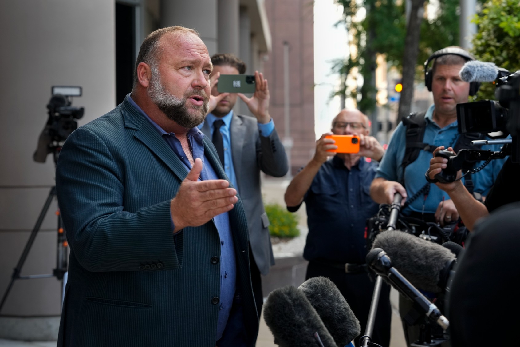 Right-wing conspiracy theorist Alex Jones speaks to the press before his bankruptcy hearing on Friday, June 14, 2024, at Bob Casey Federal Courthouse in Houston. (Yi-Chin Lee/Houston Chronicle via Getty Images)