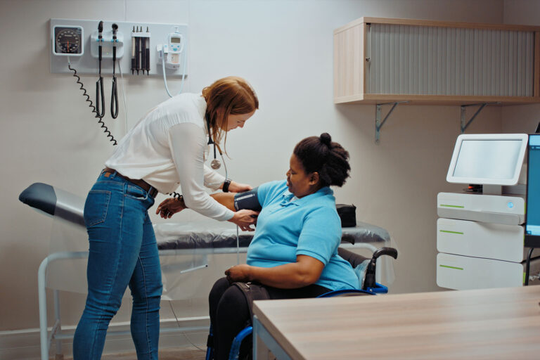 Doctor taking patient blood pressure in hospital examination room. (Getty Images/Kobus Louw)