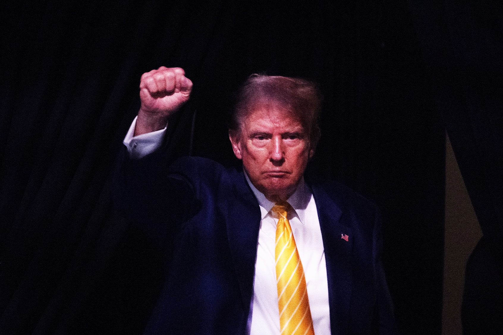 Former US President and 2024 Republican presidential candidate Donald Trump raises his fist as he walks off stage after participating in a town hall event at Dream City Church in Phoenix, Arizona, on June 6, 2024. (JIM WATSON/AFP via Getty Images)