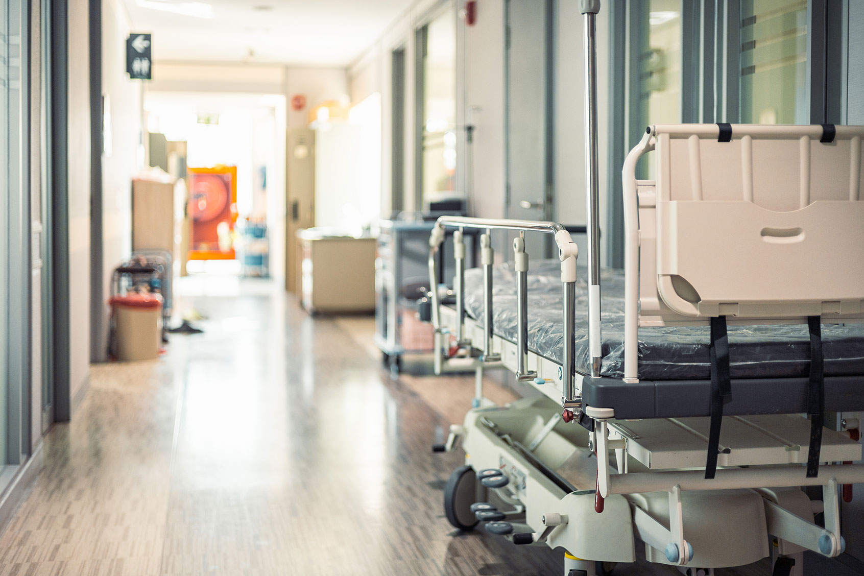 Empty hospital beds in hospital corridor (Getty Images/Jackyenjoyphotography)
