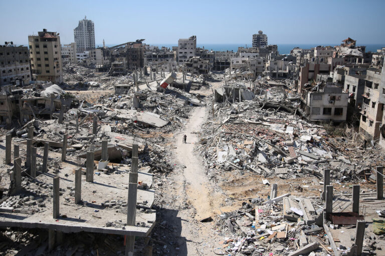 A man pushes a bycicle along as he walks amid building rubble in the devastated area around Gaza's Al-Shifa hospital on April 3, 2024, amid the ongoing conflict between Israel and the Palestinian Hamas militant group. (AFP/Getty Images)
