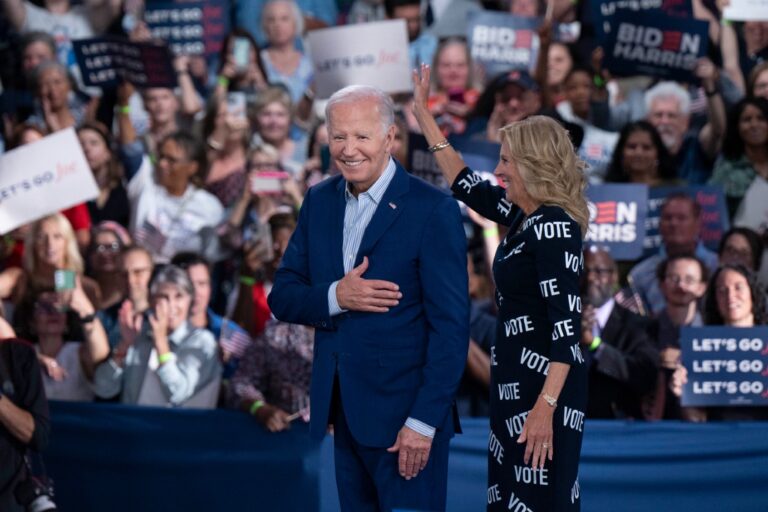 U.S. President Joe Biden and First Lady Jill Biden, with "VOTE" printed on her dress, gesture to supporters at a post-debate campaign rally on June 28, 2024 in Raleigh, North Carolina. (Allison Joyce/Getty Images)
