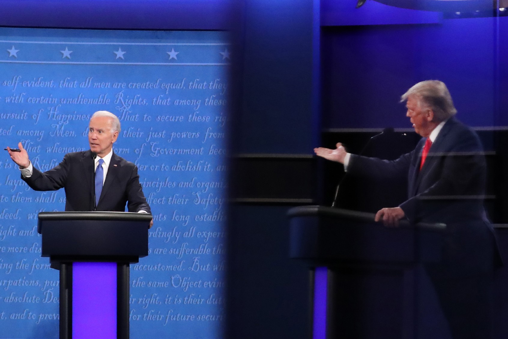 Democratic presidential nominee Joe Biden and U.S. President Donald Trump, shown in a reflection, participate in the final presidential debate at Belmont University on October 22, 2020, in Nashville, Tennessee. (Chip Somodevilla/Getty Images)