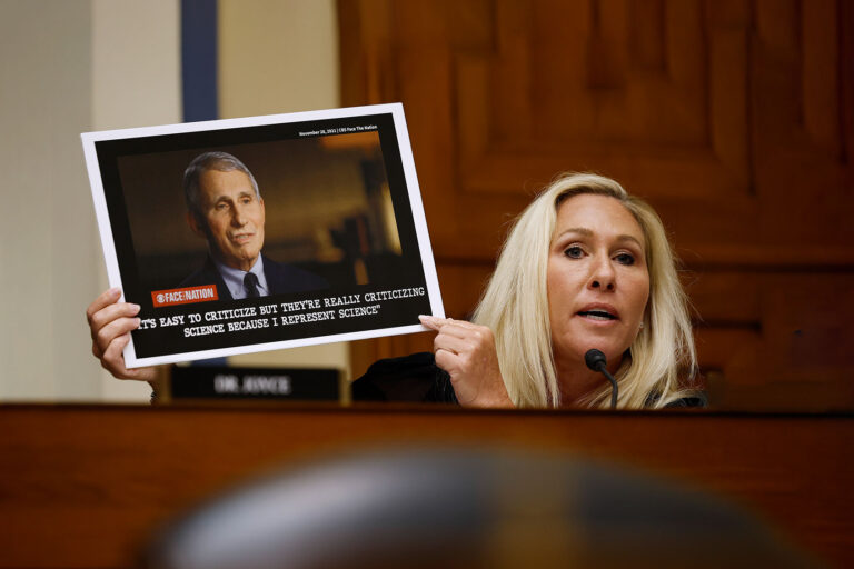 Rep. Marjorie Taylor Greene (R-GA) holds up a photograph of Dr. Anthony Fauci, former Director of the National Institute of Allergy and Infectious Diseases, while questioning him during a hearing of the House Oversight and Accountability Committee Select Subcommittee on the Coronavirus Pandemic at the Rayburn House Office Building on June 03, 2024 in Washington, DC. (Chip Somodevilla/Getty Images)