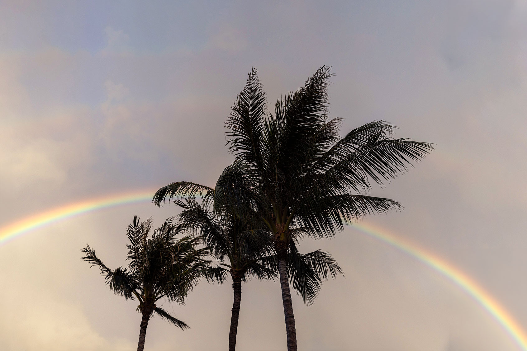 A rainbow is seen from the hotel where Val and Kali Casco have been staying near Lahaina, HI, on Aug. 29, 2023. (Tamir Kalifa for The Washington Post via Getty Images)