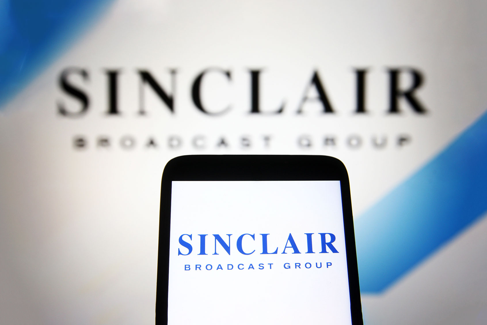 In this photo illustration a Sinclair Broadcast Group (SBG) logo is seen on a smartphone and a pc screen. (Photo Illustration by Pavlo Gonchar/SOPA Images/LightRocket via Getty Images)