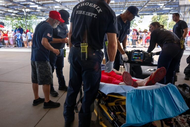 As temperatures reach 108 degrees Fahrenheit (42C), a woman is tended to for heat exhaustion as supporters line up before former U.S. President and 2024 Republican presidential candidate Donald Trump participates in a town hall event at Dream City Church in Phoenix, Arizona, on June 6, 2024. ( JIM WATSON/AFP via Getty Images)