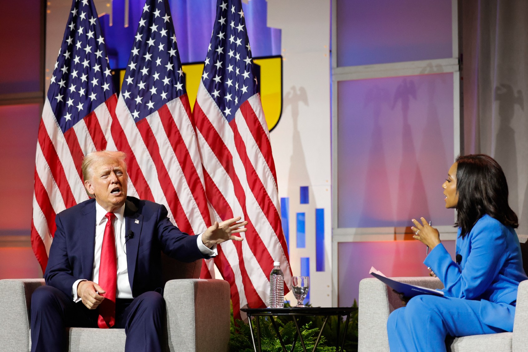 Former U.S. President and 2024 Republican presidential nominee Donald Trump answers questions as moderator and journalist Rachel Scott (R) looks on during the National Association of Black Journalists annual convention in Chicago, Illinois, on July 31, 2024. (KAMIL KRZACZYNSKI/AFP via Getty Images)