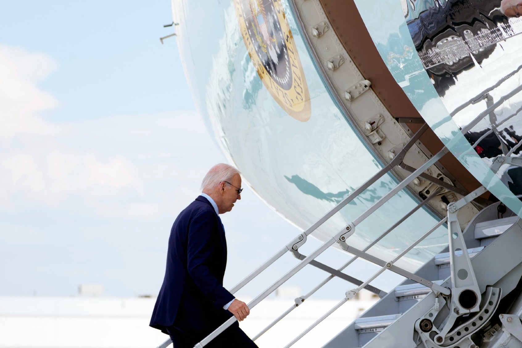 U.S. President Joe Biden boards Air Force One as he departs Harry Reid International Airport in Las Vegas, Nevada, on July 17, 2024, en route to Delaware. Biden is experiencing "mild symptoms" after testing positive for Covid during a campaign trip to Las Vegas on Wednesday, the White House said. (KENT NISHIMURA/AFP via Getty Images)