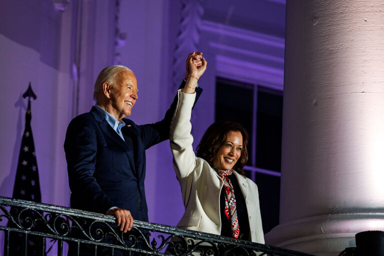 President Joe Biden and Vice President Kamala Harris join hands in the air after watching the fireworks on the National Mall with First Lady Jill Biden and Second Gentleman Doug Emhoff from the White House balcony during a 4th of July event on the South Lawn of the White House on July 4, 2024 in Washington, DC. (Samuel Corum/Getty Images)