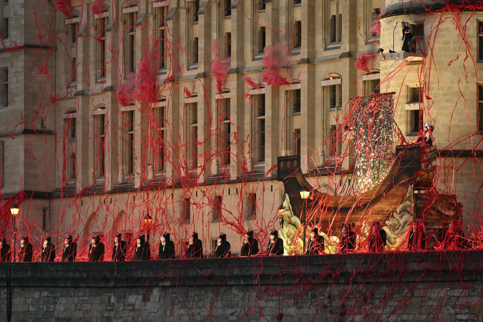 Headless figures depicting the 18th century Queen Marie Antoinette perform along the Seine river embankment outside the Conciergerie, where the queen was held captive during the French Revolution, during the Paris 2024 Olympics opening ceremony on July 26, 2024. (NATALIA KOLESNIKOVA/AFP via Getty Images)