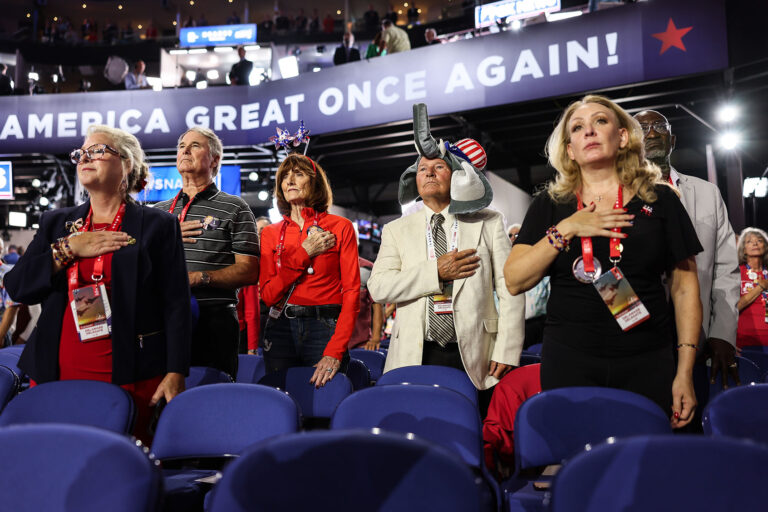 Delaware delegates stand for the National Anthem during day two of the Republican National Convention at Fiserv Forum. (Robert Gauthier/Los Angeles Times via Getty Images)