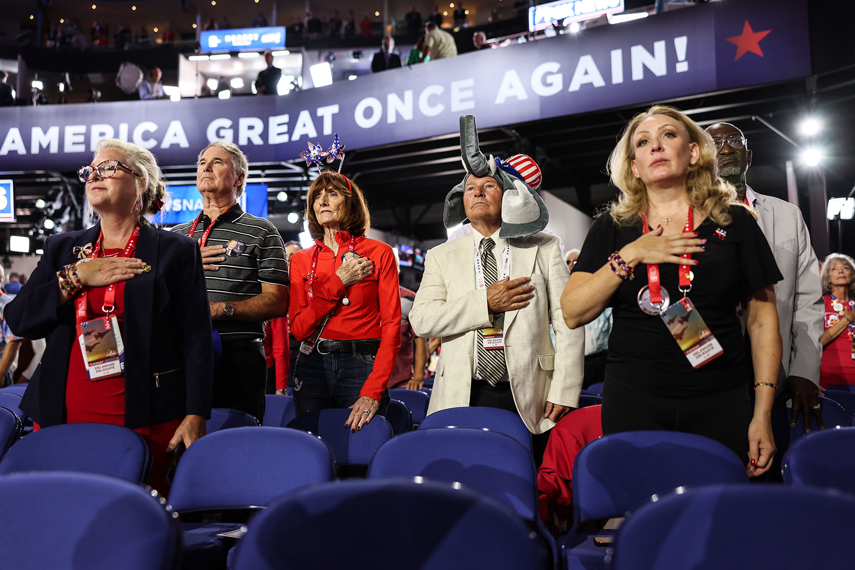 Delaware delegates stand for the National Anthem during day two of the Republican National Convention at Fiserv Forum. (Robert Gauthier/Los Angeles Times via Getty Images)