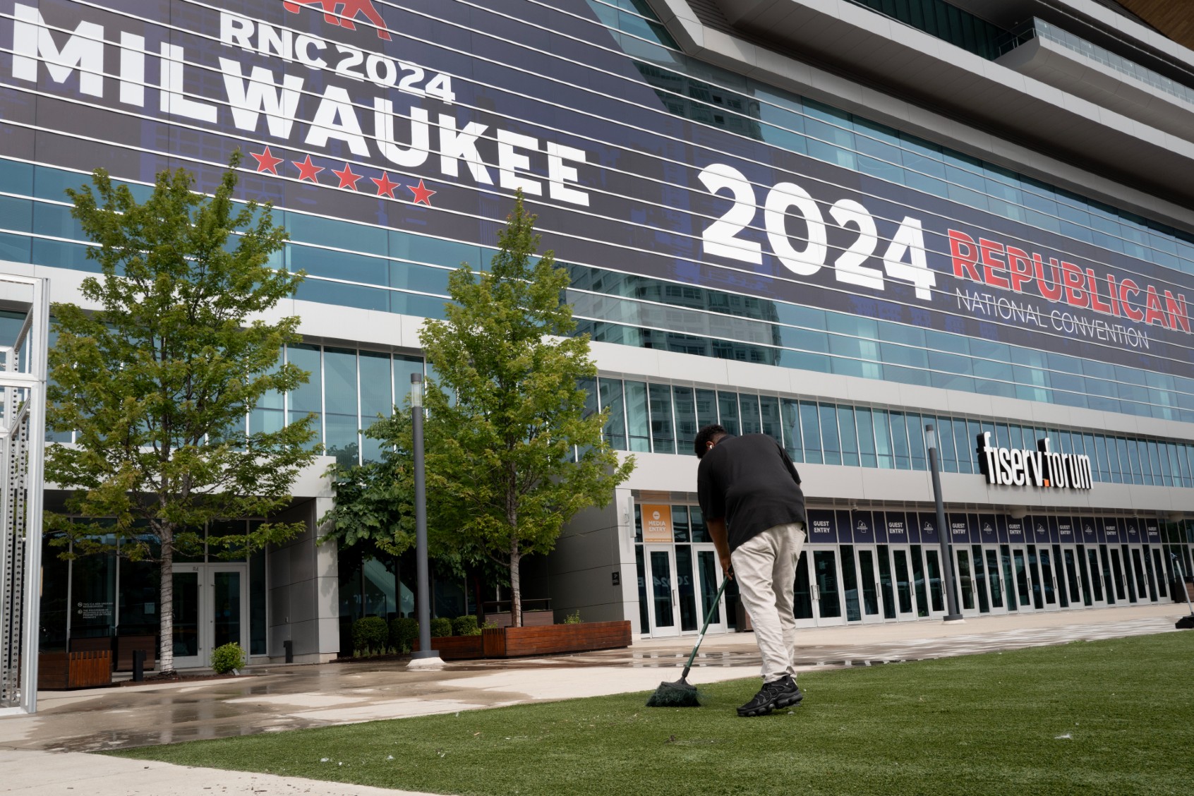 Eliezer Johnson helps to clean up the area outside of the Fiserv Forum on July 10, 2024, in Milwaukee, Wisconsin. The Republican National Convention (RNC) will be held at the Forum on July 15-18. (Scott Olson/Getty Images)