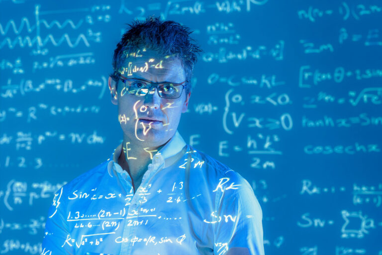 Portrait of scientist with projected mathematical data (Getty Images/Monty Rakusen)