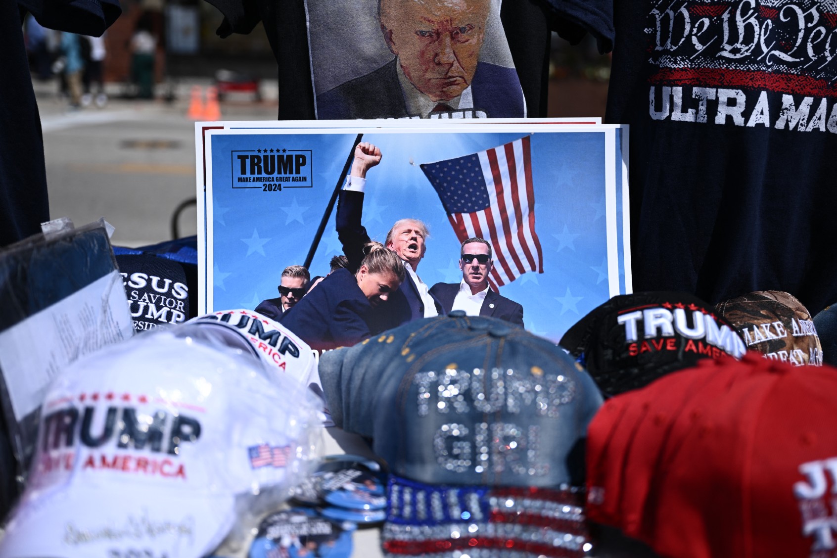 Trump merchandise is displayed for sale outside of the Fiserv Forum during the second day of the 2024 Republican National Convention in Milwaukee, Wisconsin, July 16, 2024. (BRENDAN SMIALOWSKI/AFP via Getty Images)