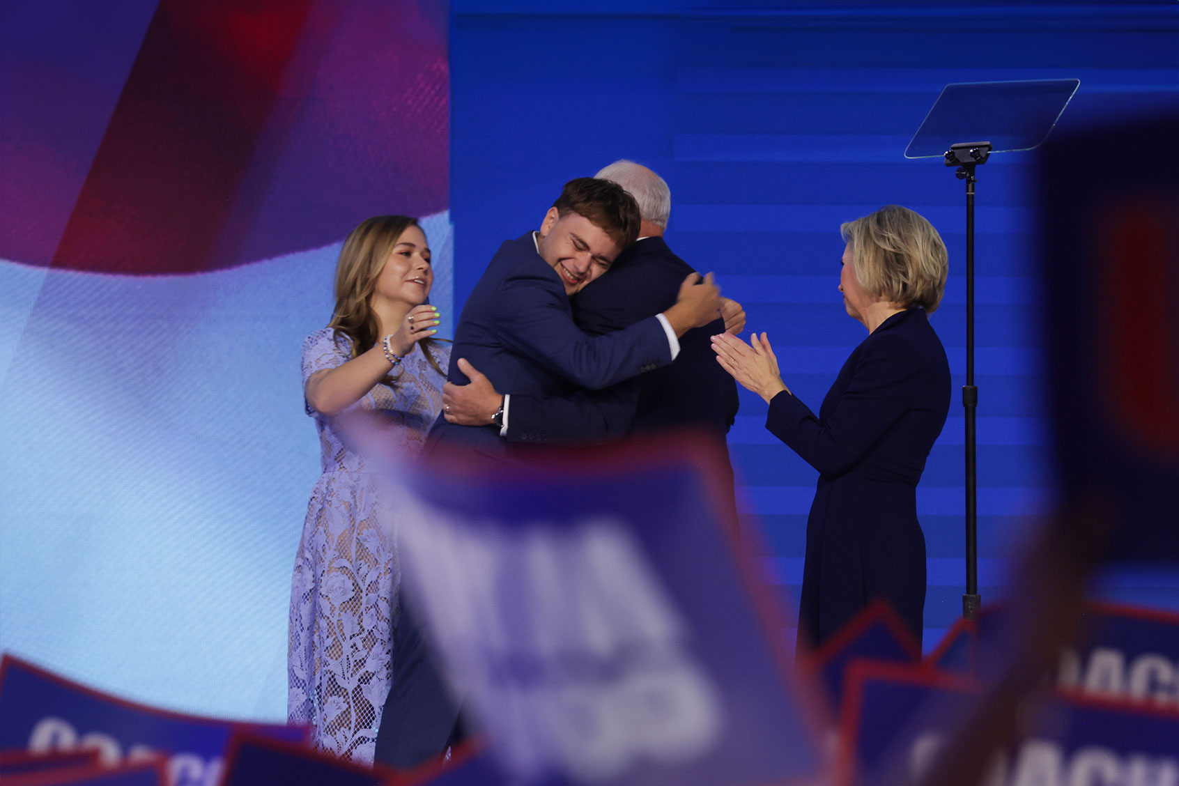 Democratic vice presidential nominee Minnesota Gov. Tim Walz celebrates with his son Gus Walz (C-L), wife Gwen Walz (R) and daughter Hope Walz (L) after accepting the Democratic vice presidential nomination on stage during the third day of the Democratic National Convention at the United Center on August 21, 2024 in Chicago, Illinois. (Alex Wong/Getty Images)