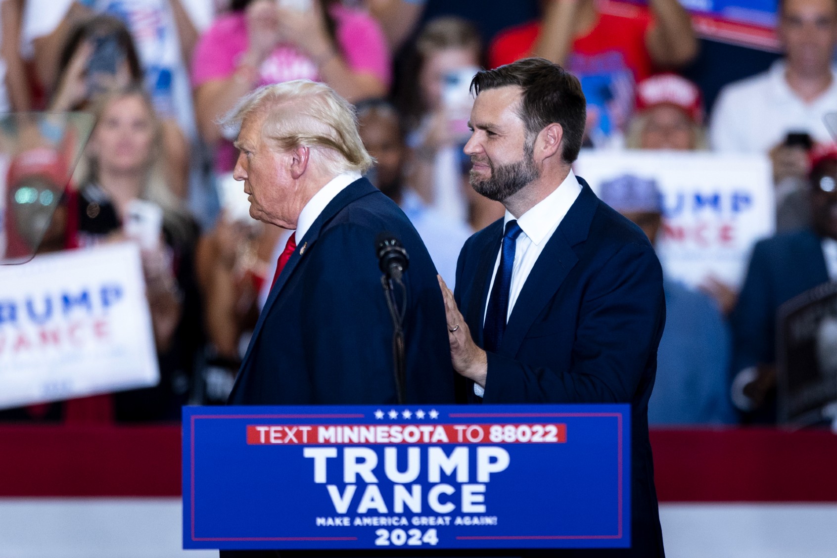 Republican presidential nominee Donald Trump is greeted by running mate Senator J.D. Vance on stage during a campaign rally inside the Herb Brooks National Hockey Center at St. Cloud State University in St. Cloud, Minnesota, on July 27, 2024. (Tom Brenner for The Washington Post via Getty Images)