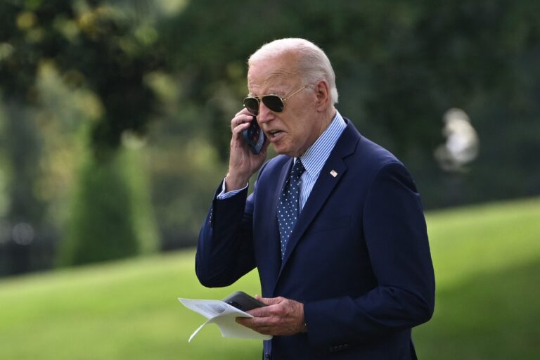 US President Joe Biden takes a phone call as he walks to board Marine One from the South Lawn of the White House in Washington, DC, on August 16, 2024. (ANDREW CABALLERO-REYNOLDS/AFP via Getty Images)